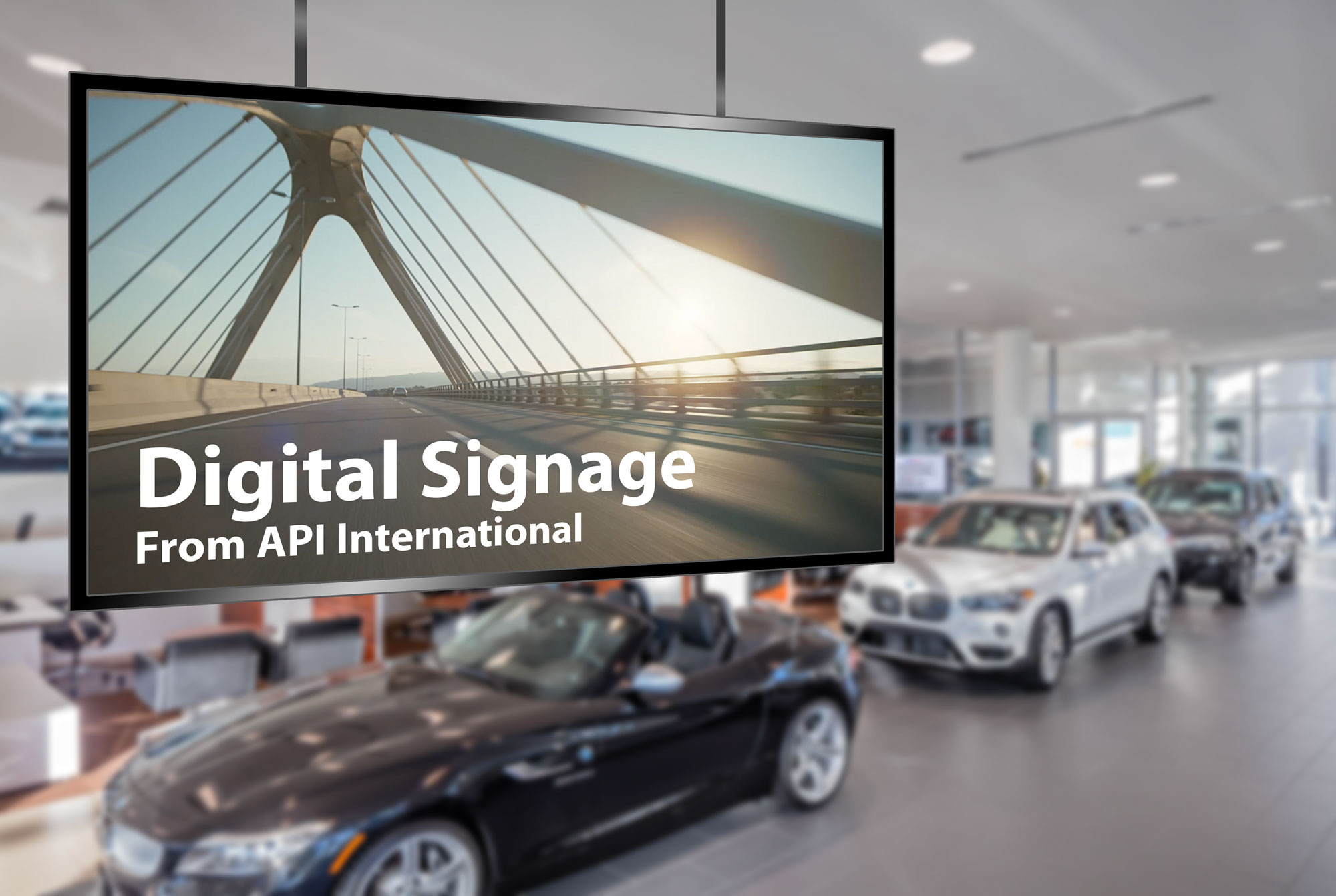 a commercial plays on a large showroom monitor with the text 'Digital Signage From API International' at the bottom of the screen